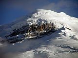 Ecuador Cotopaxi 01-07 Cotopaxi And Yanasacha Rocks At Sunset From North Here is a close up of Cotopaxi�s north face seen from Tambopaxi near sunset. The enormous black rock amidst the white snow is called, 